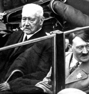 Na archívnej snímke z 1. mája 1933 nemecký prezident Paul von Hindenburg a Adolf Hitler sedia v aute počas osláv Dňa práce v Berlíne. Samospráva nemeckej metropoly Berlín odobrala vo tvrtok 27. februára 2020 titul èestného obèana niekdajiemu rískemu prezidentovi Paulovi von Hindenburgovi vzh¾adom na úlohu, ktorú zohrával v èase nástupu nacistického diktátora Adolfa Hitlera k moci. FOTO TASR/AP FILE - In this May 1, 1933 file photo German President Paul von Hindenburg, left, and Adolf Hitler, right, sit in a car during a labor day celebration in Berlin. The Berlin state government on Thursday struck the Prussian aristocrat Paul von Hindenburg off of its honorary citizen list, citing his act as president in 1933 of appointing Hitler as chancellor, the dpa news agency reported. Hindenburg was elected president in 1925 and served in that role until his death in 1934. (AP Photo)