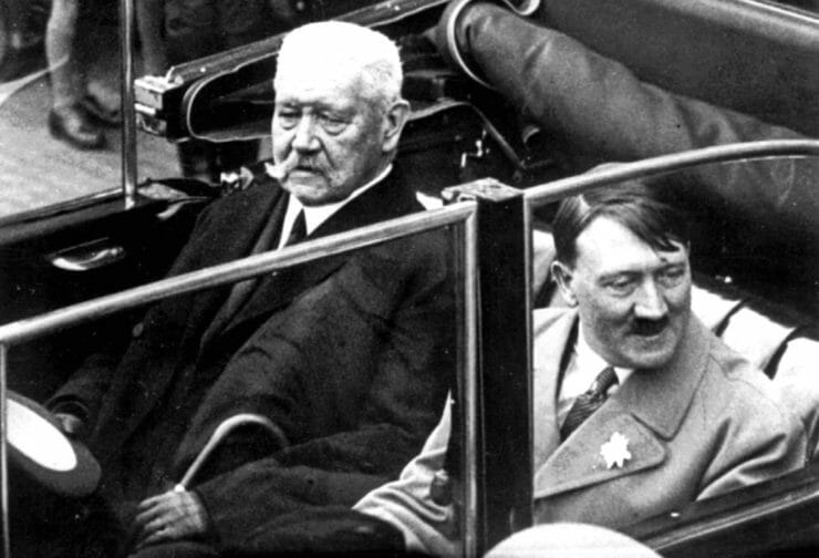 Na archívnej snímke z 1. mája 1933 nemecký prezident Paul von Hindenburg a Adolf Hitler sedia v aute počas osláv Dňa práce v Berlíne. Samospráva nemeckej metropoly Berlín odobrala vo tvrtok 27. februára 2020 titul èestného obèana niekdajiemu rískemu prezidentovi Paulovi von Hindenburgovi vzh¾adom na úlohu, ktorú zohrával v èase nástupu nacistického diktátora Adolfa Hitlera k moci. FOTO TASR/AP FILE - In this May 1, 1933 file photo German President Paul von Hindenburg, left, and Adolf Hitler, right, sit in a car during a labor day celebration in Berlin. The Berlin state government on Thursday struck the Prussian aristocrat Paul von Hindenburg off of its honorary citizen list, citing his act as president in 1933 of appointing Hitler as chancellor, the dpa news agency reported. Hindenburg was elected president in 1925 and served in that role until his death in 1934. (AP Photo)