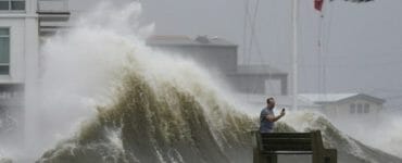 Muž si fotí vysokú vlnu pri probreží počas hurikánu Ida v americkom meste New Orleans v nedeľu 29. augusta 2021.