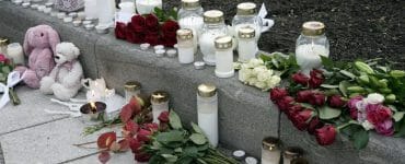Kvety a sviečky sú položené po stredajšom útoku muža v nórskom meste Kongsberg.
