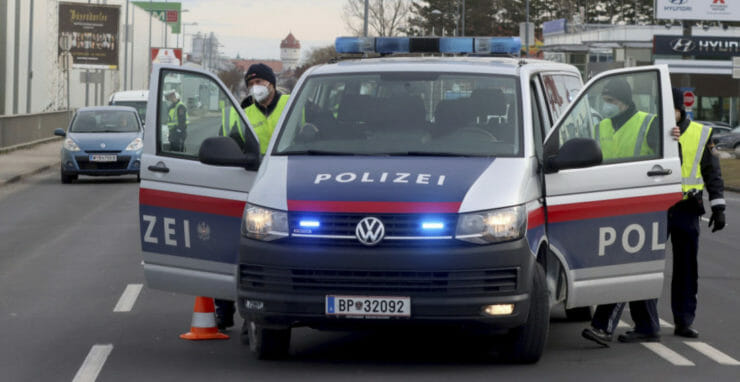 Policajti kontrolujú vodičov, ktorí chcú opustiť rakúske mesto Wiener Neustadt v sobotu 13. marca 2021.