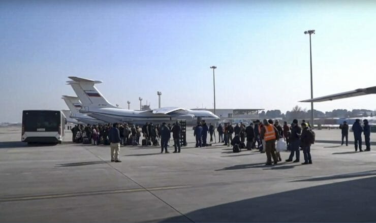 Ľudia čakajú na nástup do ruského vojenského lietadla Il-76 na letisku v Kábule 18. decembra 2021.