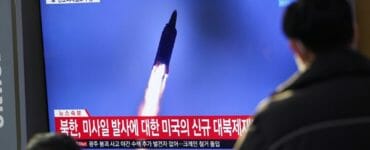 Ľudia sledujú na televíznej obrazovke vypálenie rakety Severnou Kóreou počas vysielania správ na železničnej stanici v Soule 14. januára 2022.