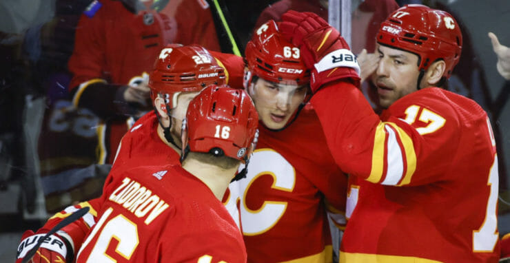 Uprostred slovenský center Calgary Adam Ružička oslavuje svoj gól v zápase hokejovej NHL Calgary Flames - Columbus Blue Jackets.
