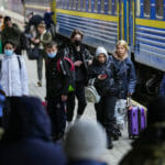 Ľudia, ktorí utekajú pred vojnovým konfliktom zo susednej Ukrajiny, vystupujú z vlaku na železničnej stanici v poľskom meste Przemyšl v piatok 25. februára 2022.