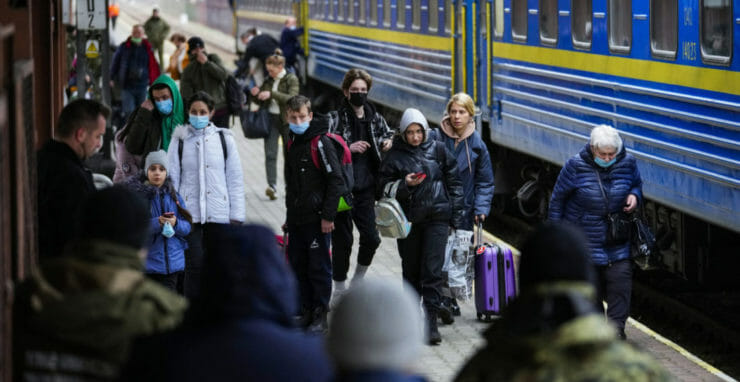 Ľudia, ktorí utekajú pred vojnovým konfliktom zo susednej Ukrajiny, vystupujú z vlaku na železničnej stanici v poľskom meste Przemyšl v piatok 25. februára 2022.