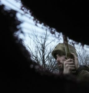 Ukrajinský vojak počúva delostreleckú paľbu v zákopoch na frontovej línii. Ukrajinský vojak počúva delostreleckú paľbu v zákopoch na frontovej línii.
