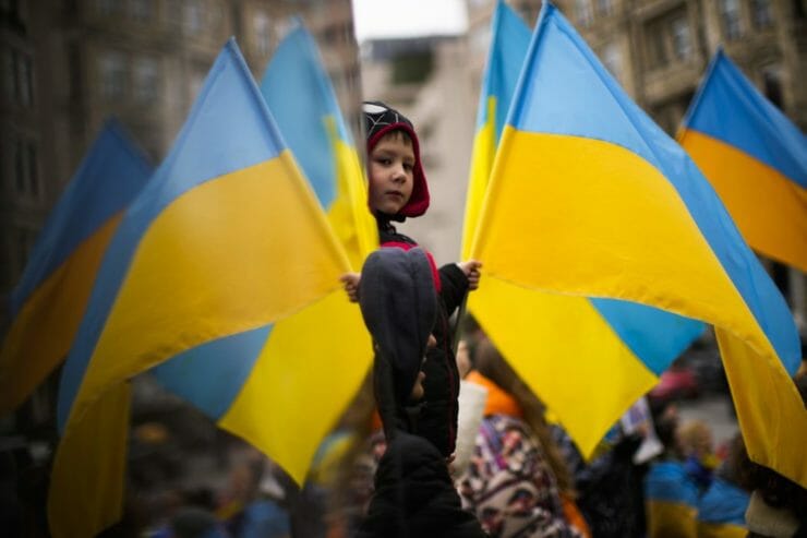 Ľudia mávajú s ukrajinskými vlajkami počas protestu proti ruskej invázii na Ukrajine v Istanbule 7. marca 2022.