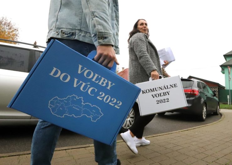 členovia volebnej komisie nesú prenosné volebné schránky v Sliači v okrese Zvolen 29. októbra 2022.