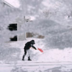 Miestny obyvateľ odhrabáva sneh z príjazdovej cesty v meste Urbandale, americkom štáte Iowa vo štvrtok 22. decembra 2022.